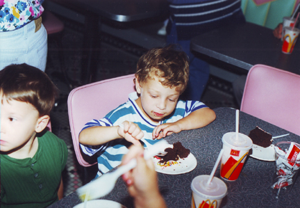 Louis dives into Tyler's Cake, Tyler on left