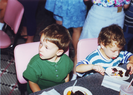 Louis dives into Tyler's Cake, Tyler on left