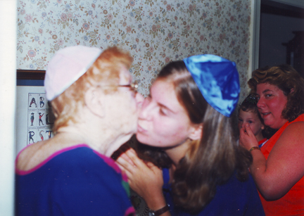 Grandma Marion & Cousin Sarah exchange a kiss with Louis & Jill in the background
