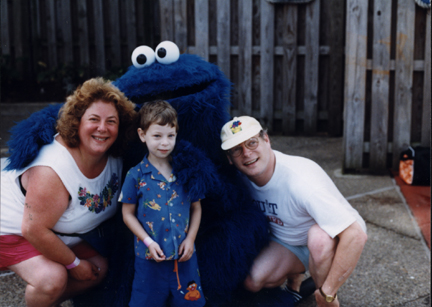 Jill, Louis & Howard Parnes with Cookie Monster