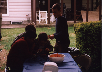 Louis at head of table surrounded by friends