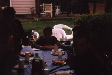 Louis at head of table surrounded by friends