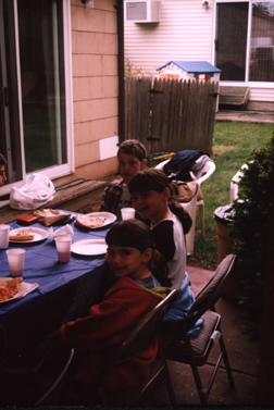 Louis at head of table surrounded by friends